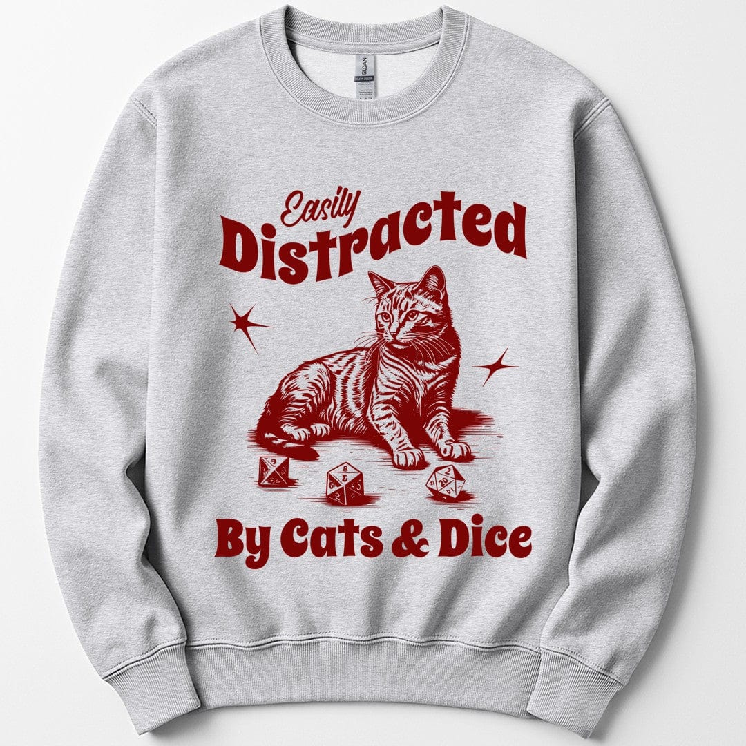 Ash sweatshirt. Reads "Easily Distracted" across the top, Easily in a slanted script and Distracted in fat retro capitals, and "By Cats and Dice" across the bottom in the same fat style. Between them a striped tabby cat sits upright with its tail curled and three polyhedral dice scattered by its paws, a starburst either side. Vintage engraved linework in a single deep crimson.