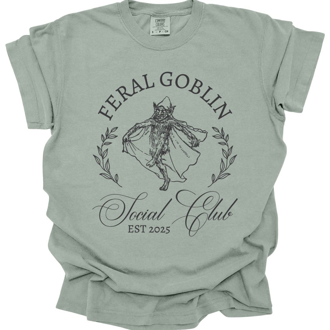 The same Feral Goblin Social Club, cat design, on a bay t-shirt.