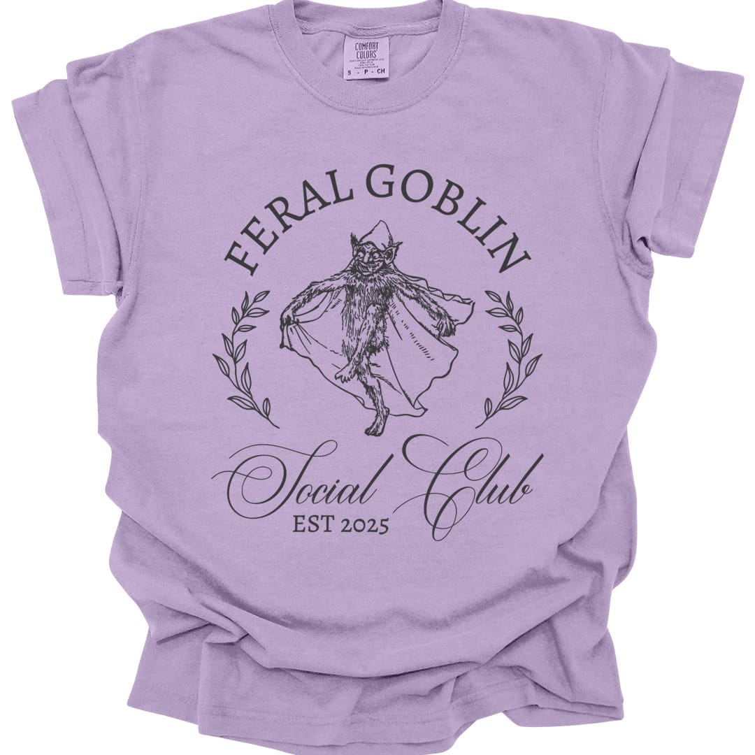 The same Feral Goblin Social Club, cat design, on an orchid t-shirt.