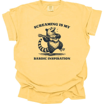 The same Bardic Inspiration possum design, on a butter t-shirt.