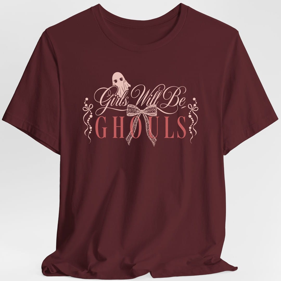 The same Girls Will Be Ghouls coquette design, on a maroon t-shirt.
