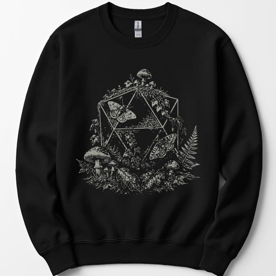 Black sweatshirt. A twenty-sided die outline sits behind a large moth with spread wings, surrounded by toadstools, ferns and leaves. Everything is drawn in fine dotted stipple shading, all in a single pale cream. No words.
