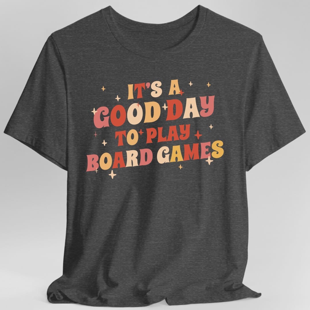 The same Good Day to Play Board Games, groovy design, on a dark heather t-shirt.