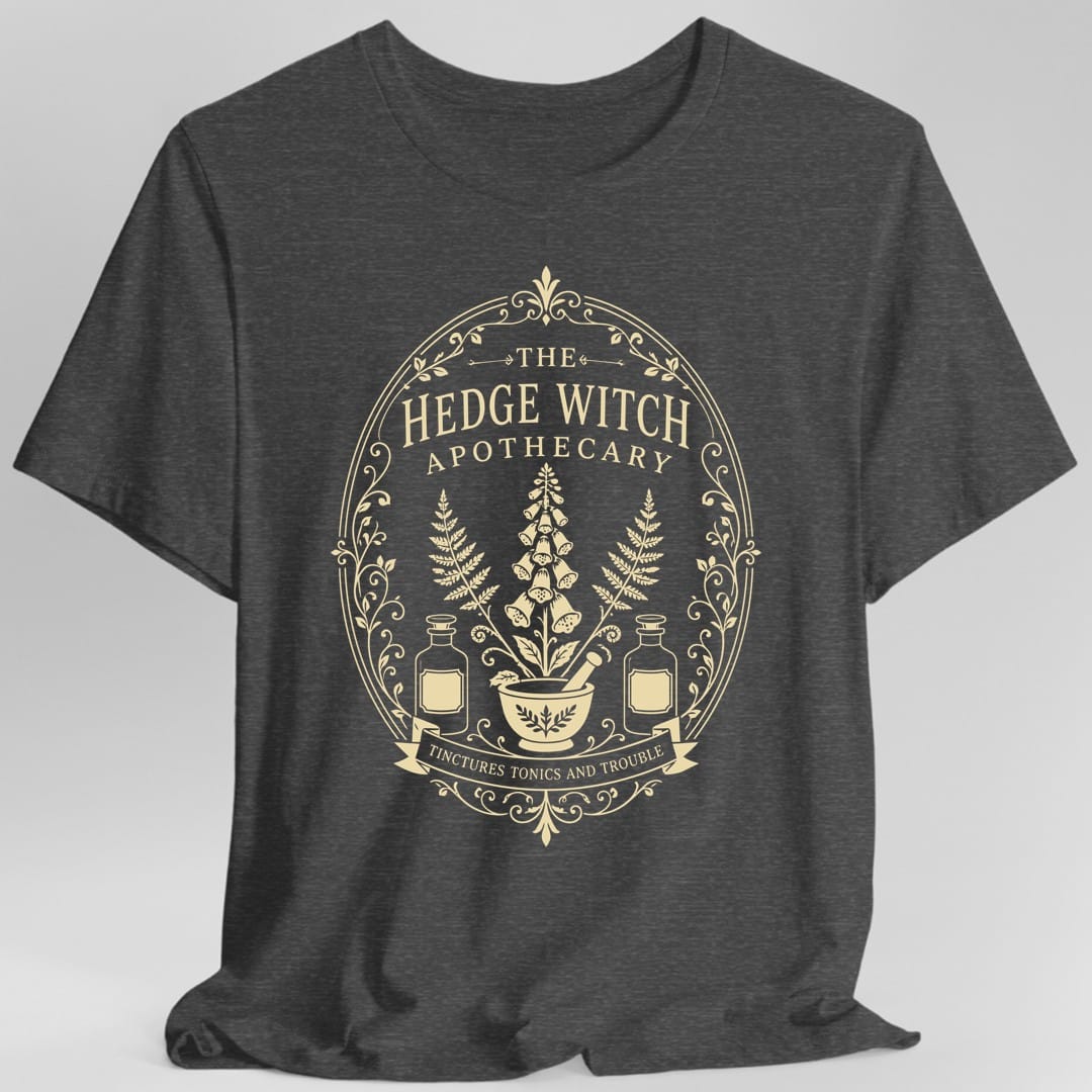The same Hedge Witch Apothecary label design, on a dark heather t-shirt.