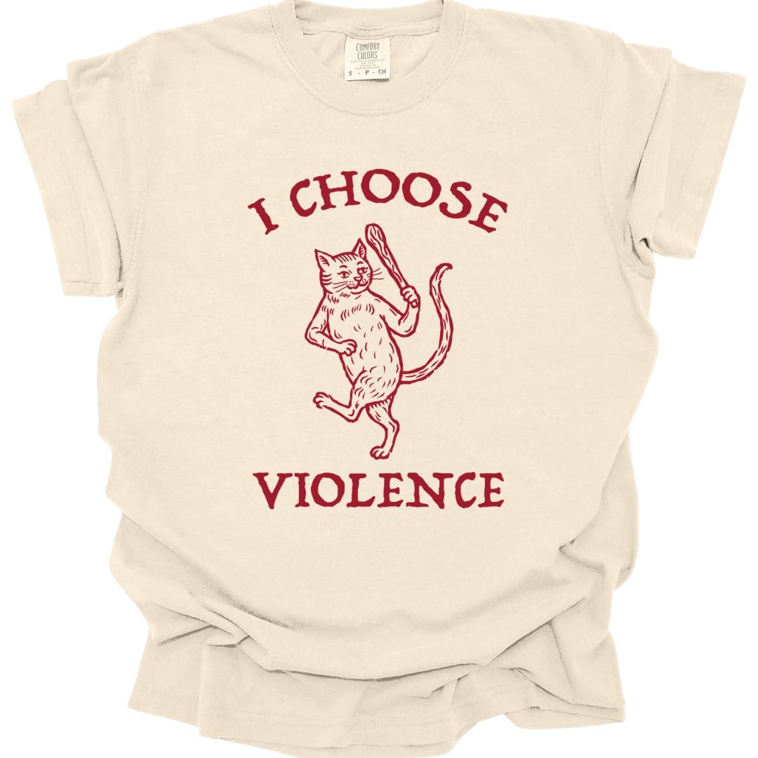 Ivory t-shirt. Reads "I choose" curving across the top and "Violence" across the bottom in red capitals. Between them a cat stands upright on its hind legs with one paw raised mid-swipe, drawn in fine red engraved linework.