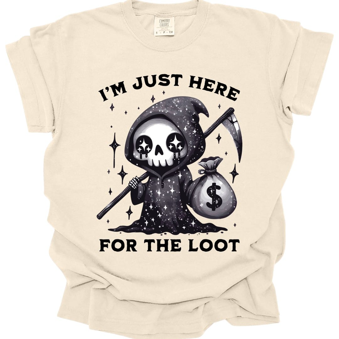 Ivory t-shirt. Reads "I'm just here" across the top and "For the loot" across the bottom in bold capitals. Between them a small grim reaper in a starry black hood holds a scythe in one hand and a money bag in the other, its skull face marked with star-shaped eyes.