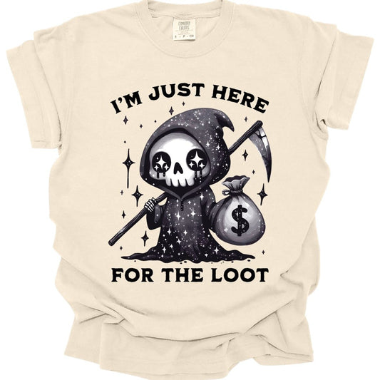 Ivory t-shirt. Reads "I'm just here" across the top and "For the loot" across the bottom in bold capitals. Between them a small grim reaper in a starry black hood holds a scythe in one hand and a money bag in the other, its skull face marked with star-shaped eyes.