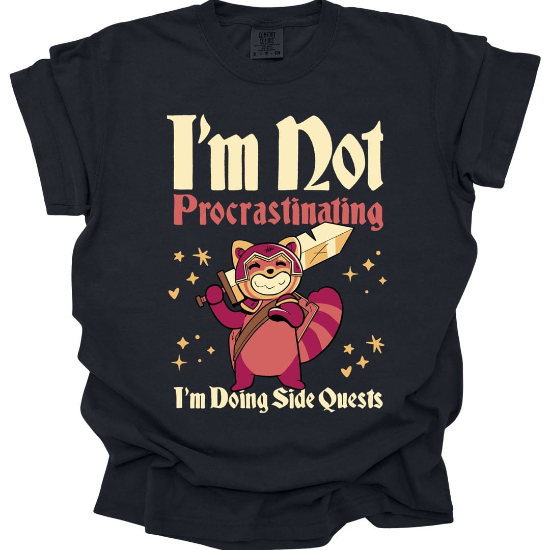 Black t-shirt. Reads "I'm not" in large cream letters with "Procrastinating" in coral script beneath, and "I'm doing side quests" in cream script across the bottom. Between them a red panda in a headband strides forward with a huge wooden sword over its shoulder, sparkles around it.
