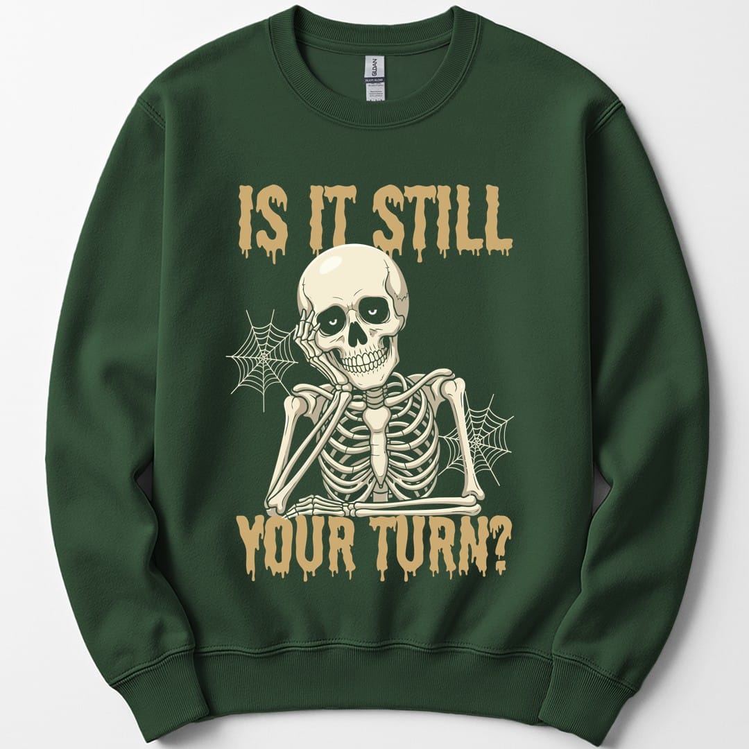 The same Is It Still Your Turn skeleton design, on a forest green sweatshirt.