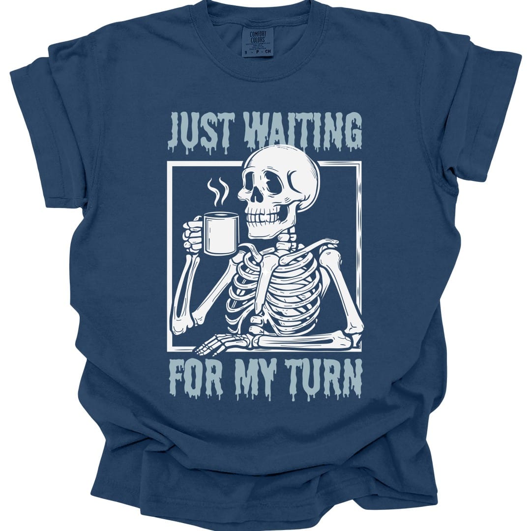 The same Just Waiting For My Turn skeleton design, on a true navy t-shirt.