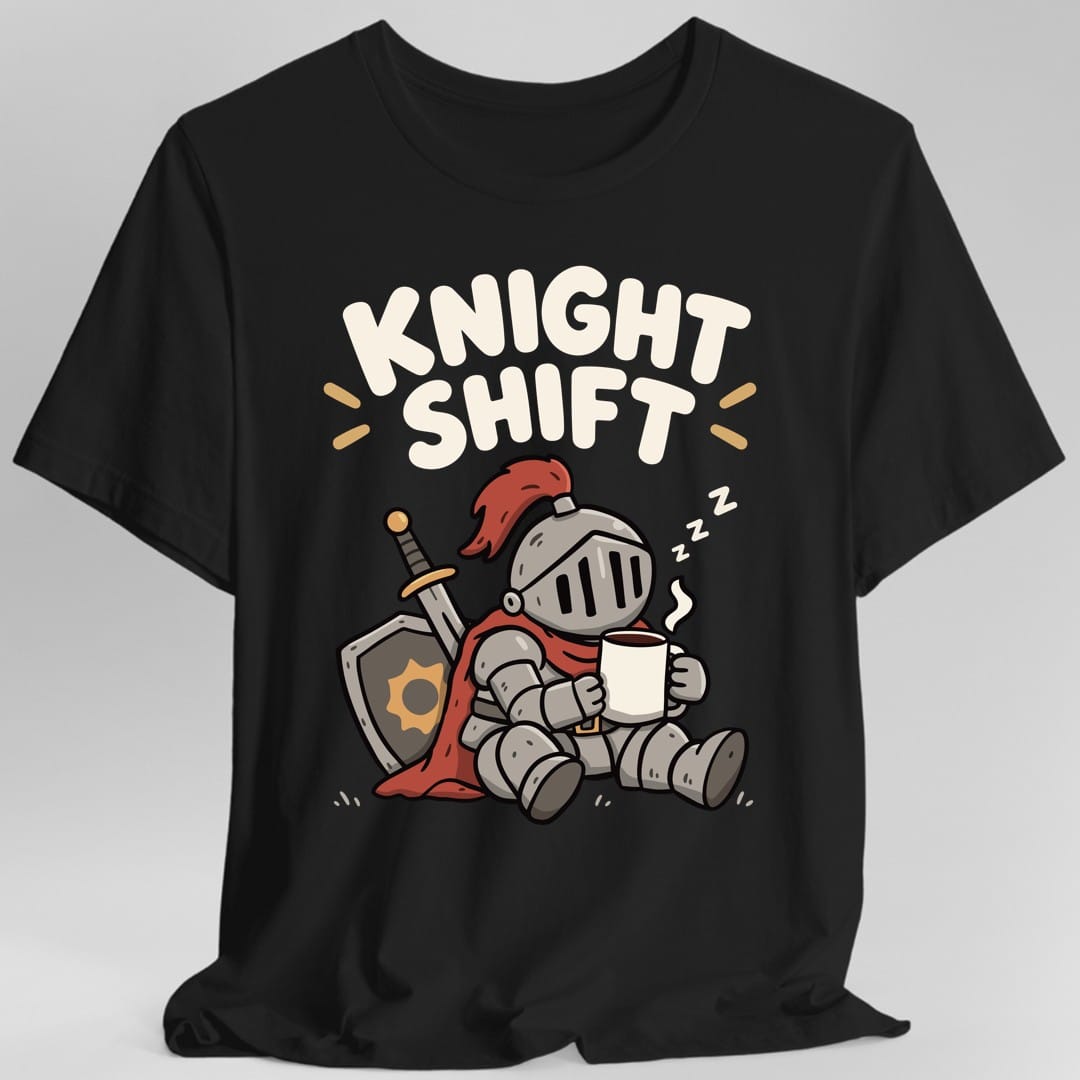Black t-shirt. The design reads "Knight Shift" in chunky rounded cream lettering across the top. Below, a chubby cartoon knight in full gray plate armor with a red plume and red cape sits slumped on the ground, leaning against a round shield with a sun emblem and a sheathed sword. The knight holds a steaming white mug in both hands, with three small Z letters floating up to show he is dozing. Cute kawaii cartoon style with bold outlines.