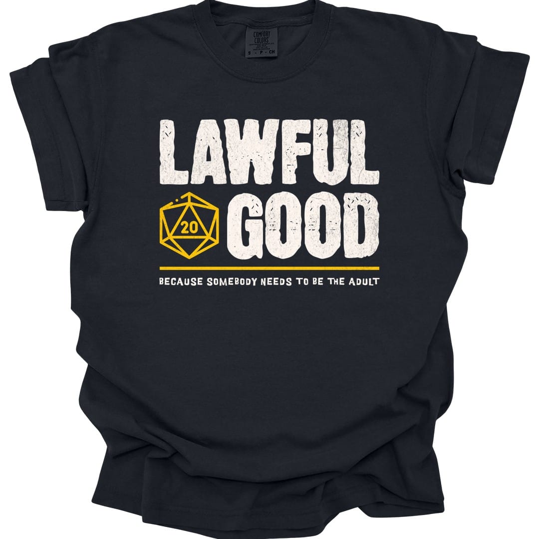 Black t-shirt. Reads "Lawful" then "Good" in tall rough cream capitals stacked over two lines. A gold outlined twenty-sided die showing 20 is tucked to the left of the word "Good". A gold rule runs underneath, and below that a smaller cream line reads "Because somebody needs to be the adult." All type, no illustration.