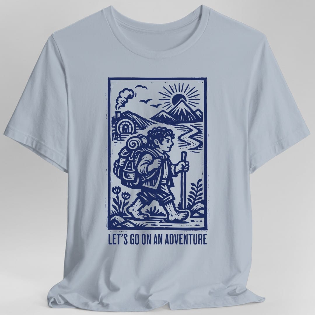 The same Let's Go On An Adventure block print design, on a light blue t-shirt.