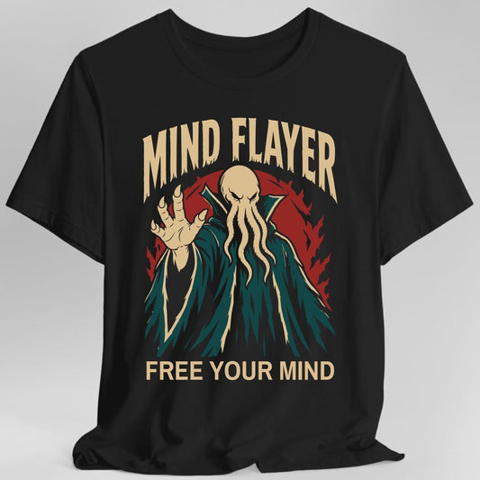 Black t-shirt. The design reads "MIND FLAYER" in tall cream letters across the top and "FREE YOUR MIND" along the bottom. Between them a mind flayer stands in a ragged teal robe, its bald tan head hung with four thick tentacles over its mouth and its eyes narrowed. One long-fingered hand is raised toward the viewer. A dark red circle and jagged red flames fan out behind it.
