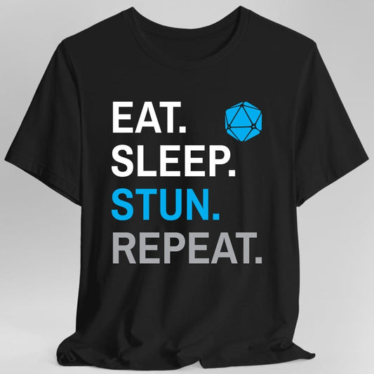 Black t-shirt. Four words stacked in heavy block capitals on four lines: "Eat." and "Sleep." in white, then "Stun." in azure blue, then "Repeat." in gray. A azure blue twenty-sided die sits in the top right corner beside the word Eat. All type, no illustration.
