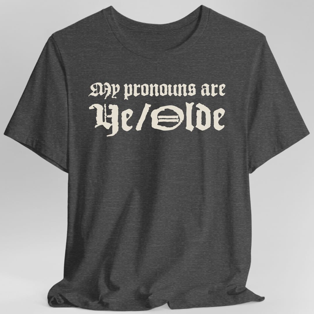 The same My Pronouns Are Ye Olde design, on a dark heather t-shirt.