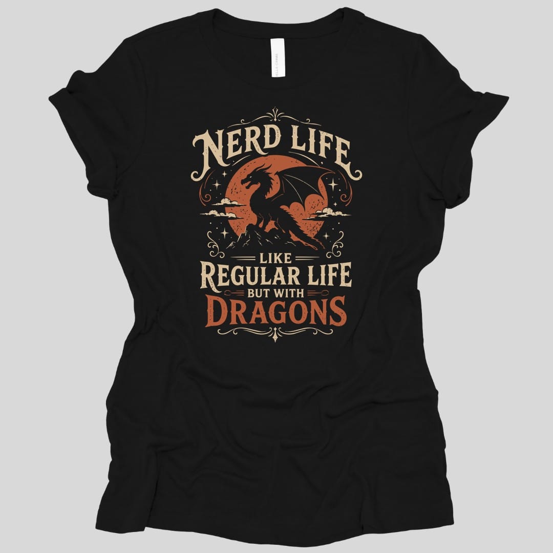 Black women's t-shirt. Reads "Nerd Life" across the top in cream capitals, then "Like regular life but with" in smaller type, and "Dragons" in large orange letters at the bottom. Between the lines two orange dragons fly over clouds and a mountain peak, with sparkles around them.