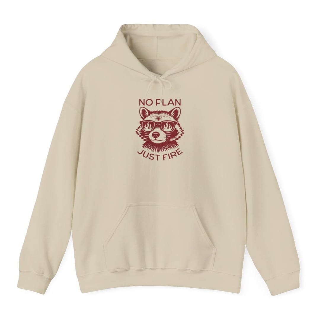 Sand hoodie. Reads "No plan" across the top and "Just fire" across the bottom in dark red capitals. Between them a raccoon faces forward wearing sunglasses with flames reflected in the lenses. Drawn in engraved lines, all in a single deep red.