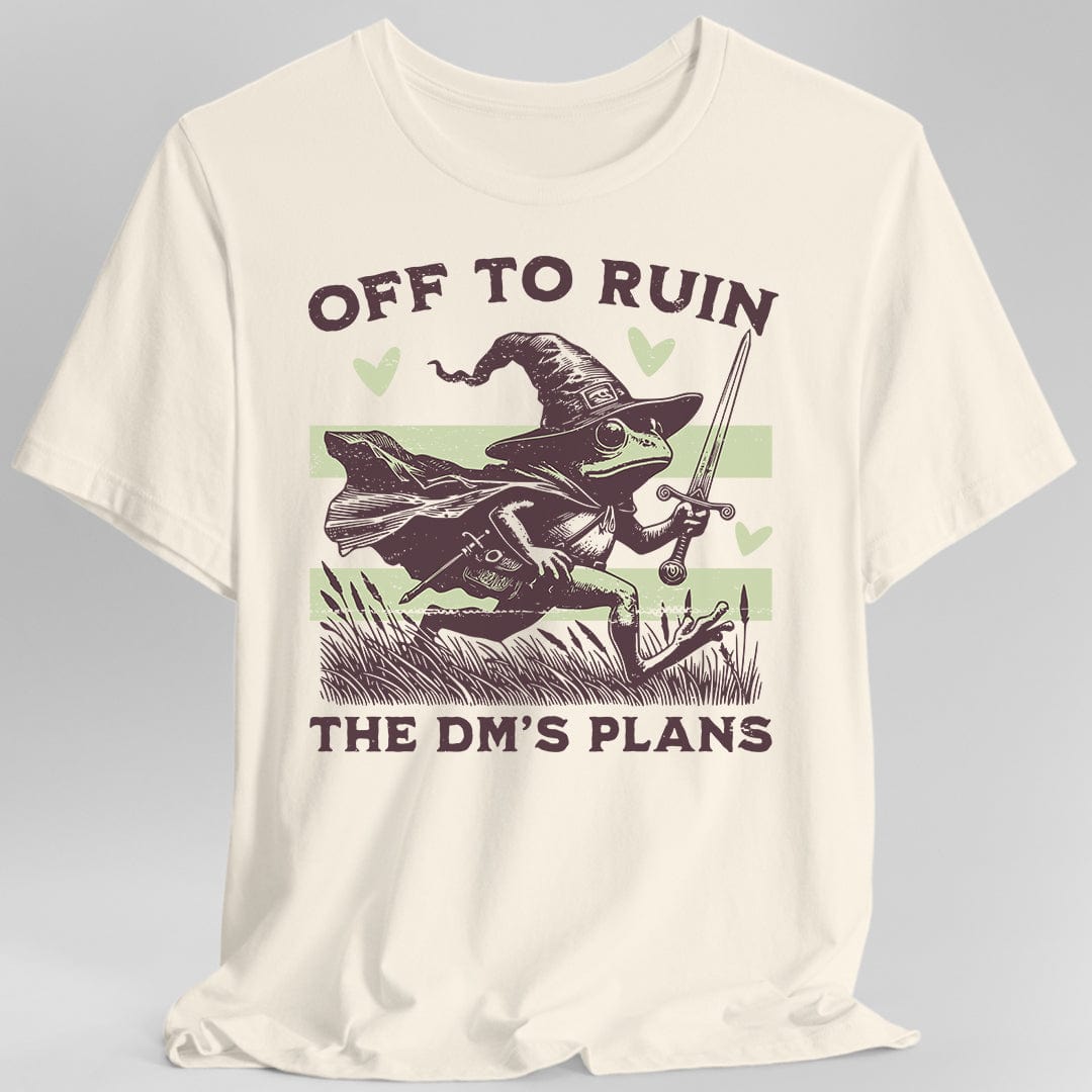 Reads "Off to ruin" across the top and "the DM's plans" across the bottom in chunky deep plum capitals. Between them a frog in a floppy pointed wizard hat and cape dashes to the right through reeds and cattails, holding a sword aloft. Two pale sage stripes run behind it and three sage hearts float around it. Retro woodcut style in deep plum and pale sage green.