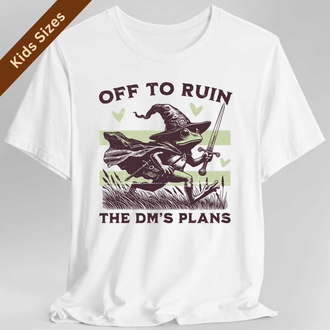 White kids t-shirt. Reads "Off to ruin" across the top and "the DM's plans" across the bottom in chunky deep plum capitals. Between them a frog in a floppy pointed wizard hat and cape dashes to the right through reeds and cattails, holding a sword aloft. Two pale sage stripes run behind it and three sage hearts float around it. Retro woodcut style in deep plum and pale sage green.