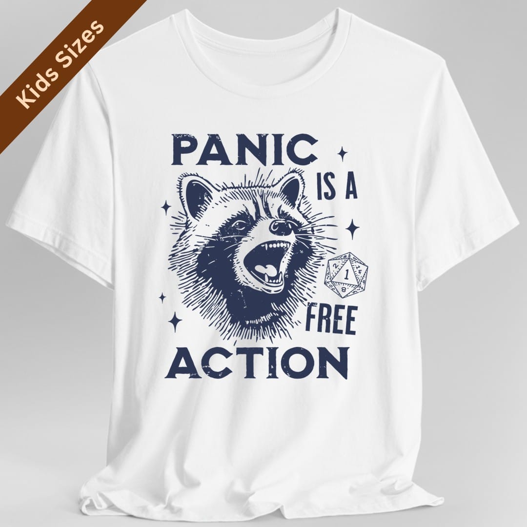 White kids t-shirt. Reads "Panic" across the top, "is a" and "free" down the right side and "Action" across the bottom, all in distressed navy capitals. In the middle a wide-eyed raccoon head throws its mouth open mid-scream, drawn in scratchy vintage engraving lines. A twenty-sided die showing a 1 sits beside it and four-pointed sparkles scatter around. Single navy ink.