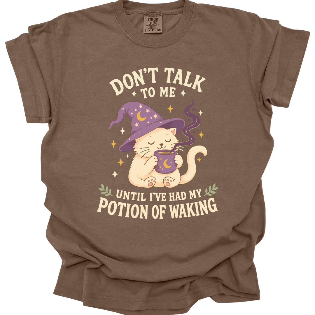 The same Potion Of Waking cat design, on an espresso t-shirt.