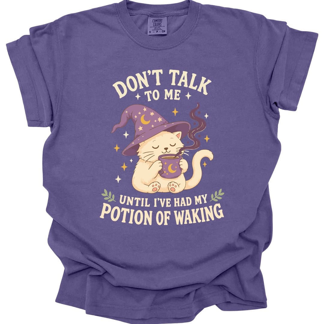 The same Potion Of Waking cat design, on a grape t-shirt.