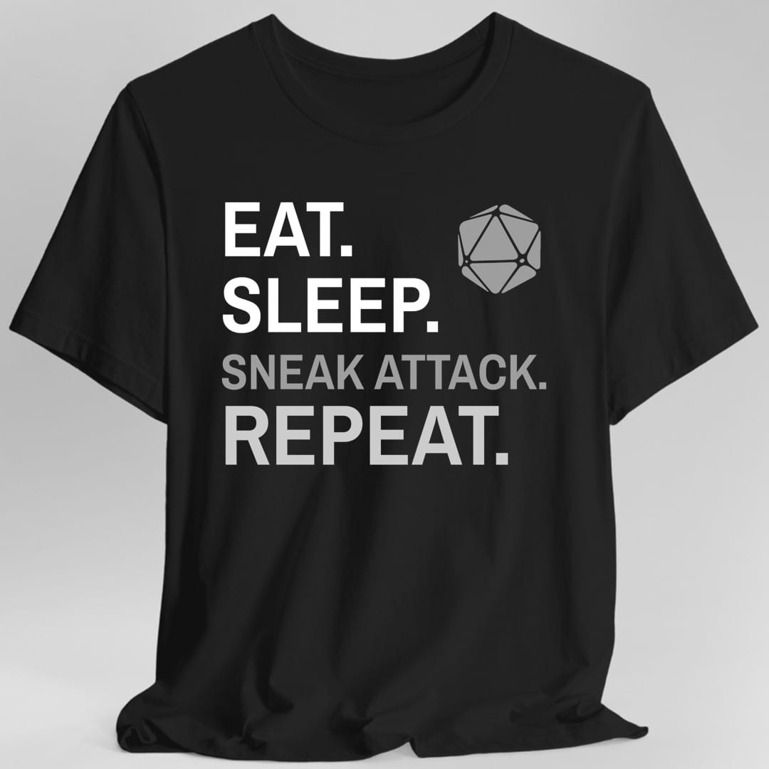 Black t-shirt. Four words stacked in heavy block capitals on four lines: "Eat." and "Sleep." in white, then "Sneak attack." in gray, then "Repeat." in gray. A gray twenty-sided die sits in the top right corner beside the word Eat. All type, no illustration.