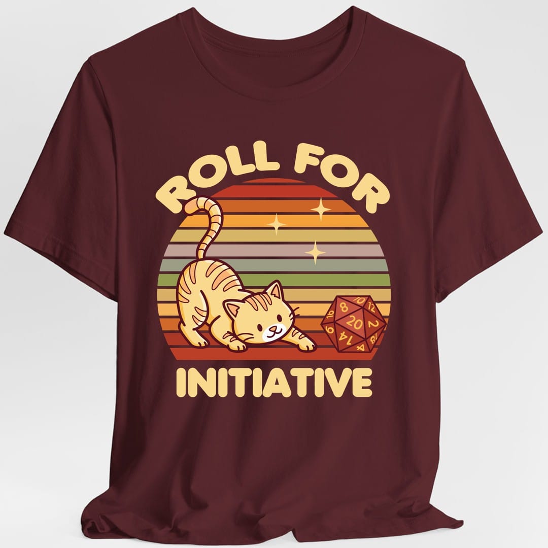 The same Roll For Initiative kawaii cat design, on a maroon t-shirt.