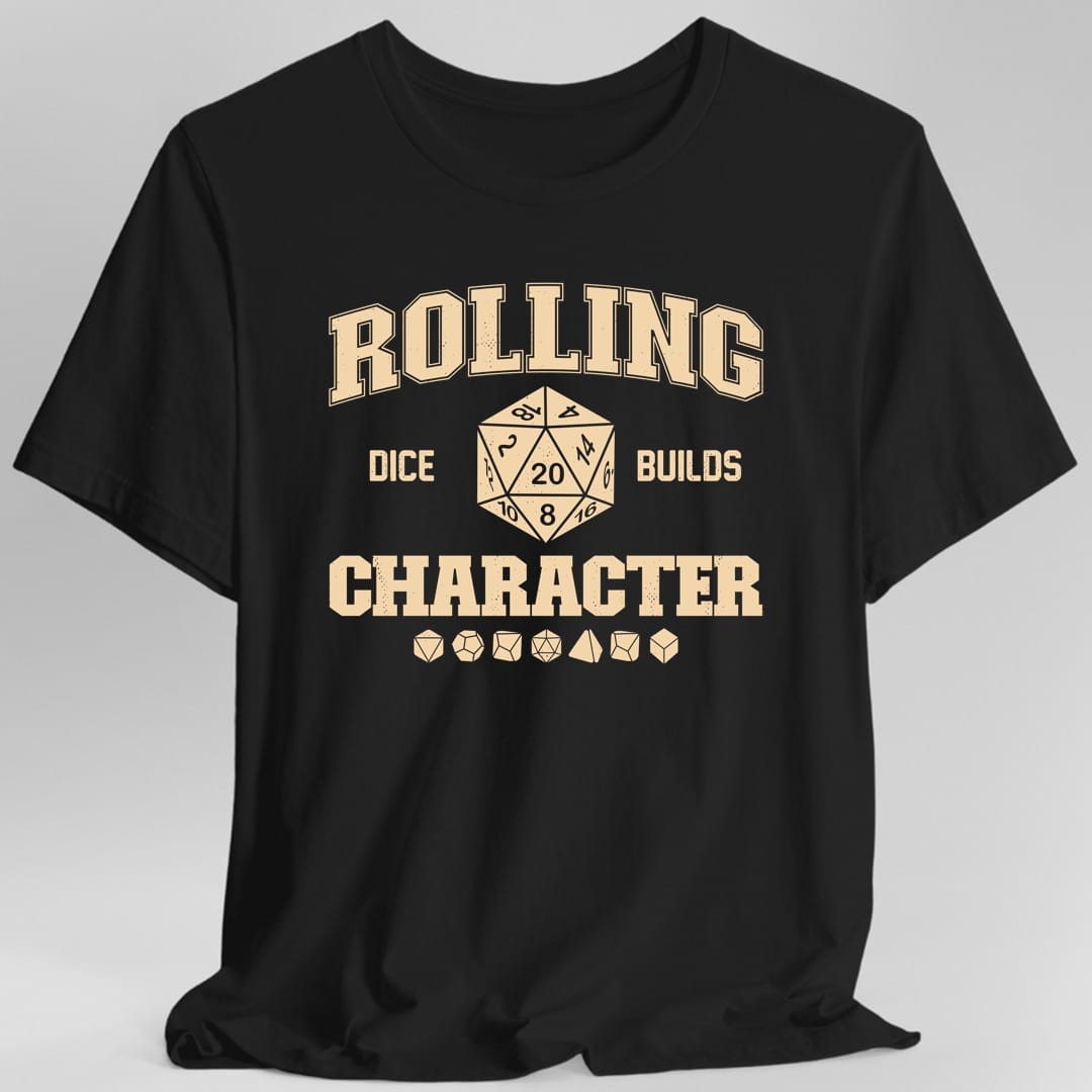 Black t-shirt. The design reads "Rolling" in tall collegiate letters across the top, then "dice" and "builds" either side of a large twenty sided die showing the number 20, then "Character" in bold slab capitals below. A row of seven polyhedral dice sits underneath. Distressed varsity athletic style, printed in a single ink.