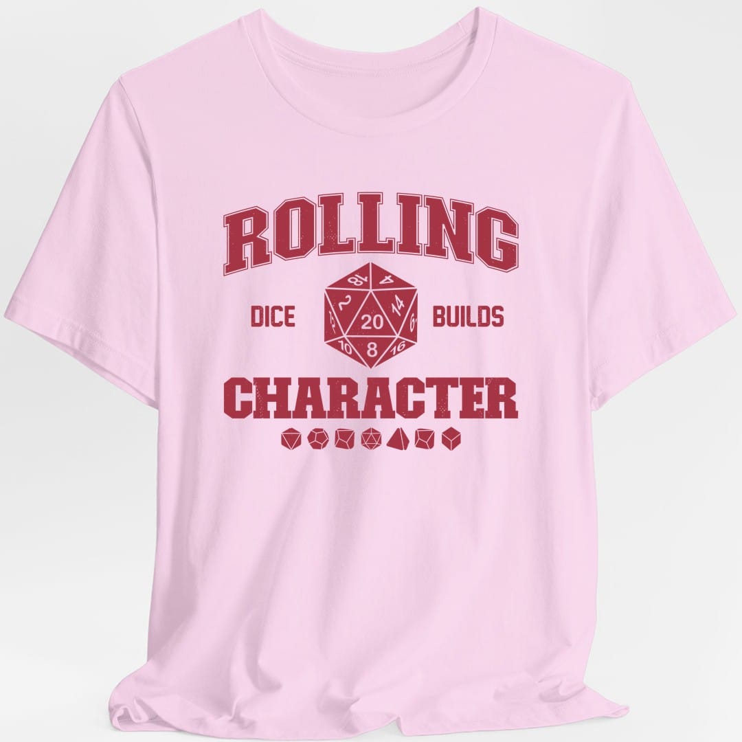 The same Rolling Dice Builds Character design, on a light pink t-shirt.