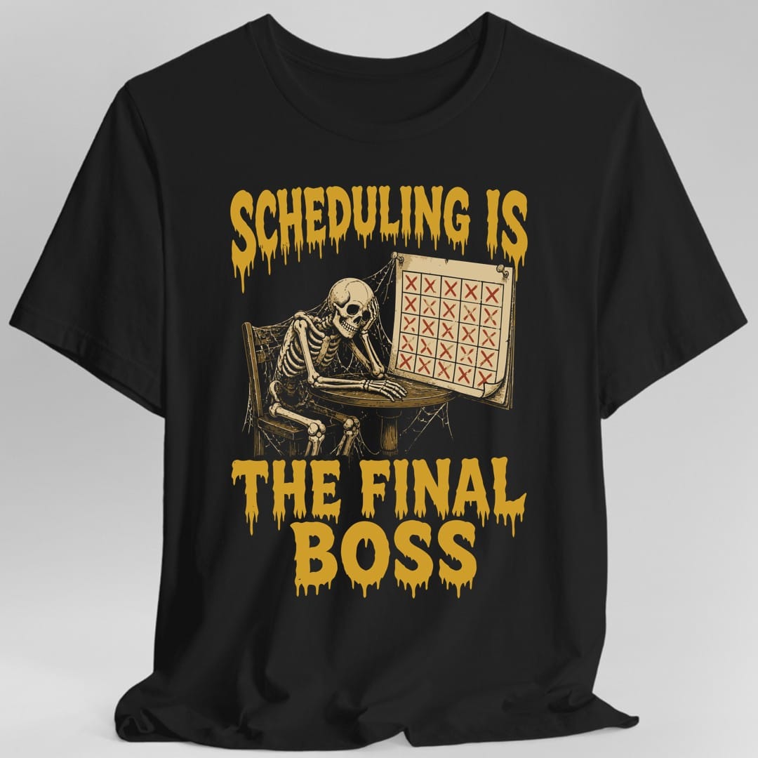 Black t-shirt. The design reads Scheduling Is across the top and The Final Boss across the bottom, both in dripping yellow horror lettering. In between, a skeleton draped in cobwebs slumps at a small table with its skull resting in one bony hand, next to a large wall calendar whose squares are all crossed out with red X marks.