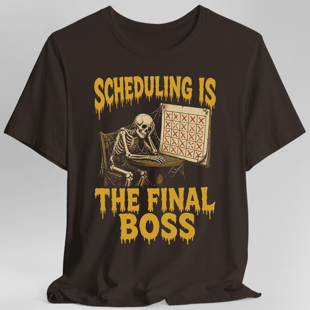 The same Scheduling Is The Final Boss design, on a dark chocolate t-shirt.