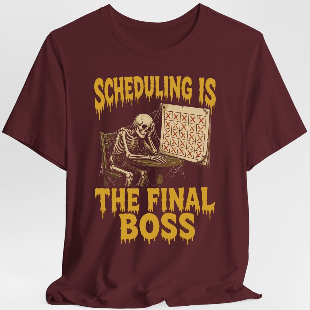 The same Scheduling Is The Final Boss design, on a maroon t-shirt.