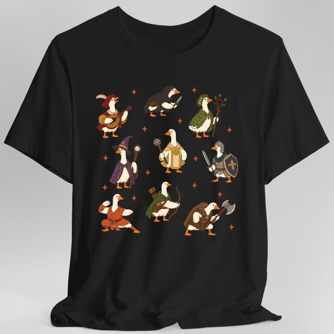 Black t-shirt. Nine white geese in three rows, each dressed as a fantasy adventuring class: a bard in a feathered red hat with a lute, a hooded rogue with a dagger, a druid in leaves with a staff, a wizard in a starry purple cloak, a cleric in gold robes with a mace, a knight with a sword and blue shield, a monk in orange robes, a ranger in a green cloak with a bow, and a barbarian in furs with an axe. Orange sparkles sit between them. No words.