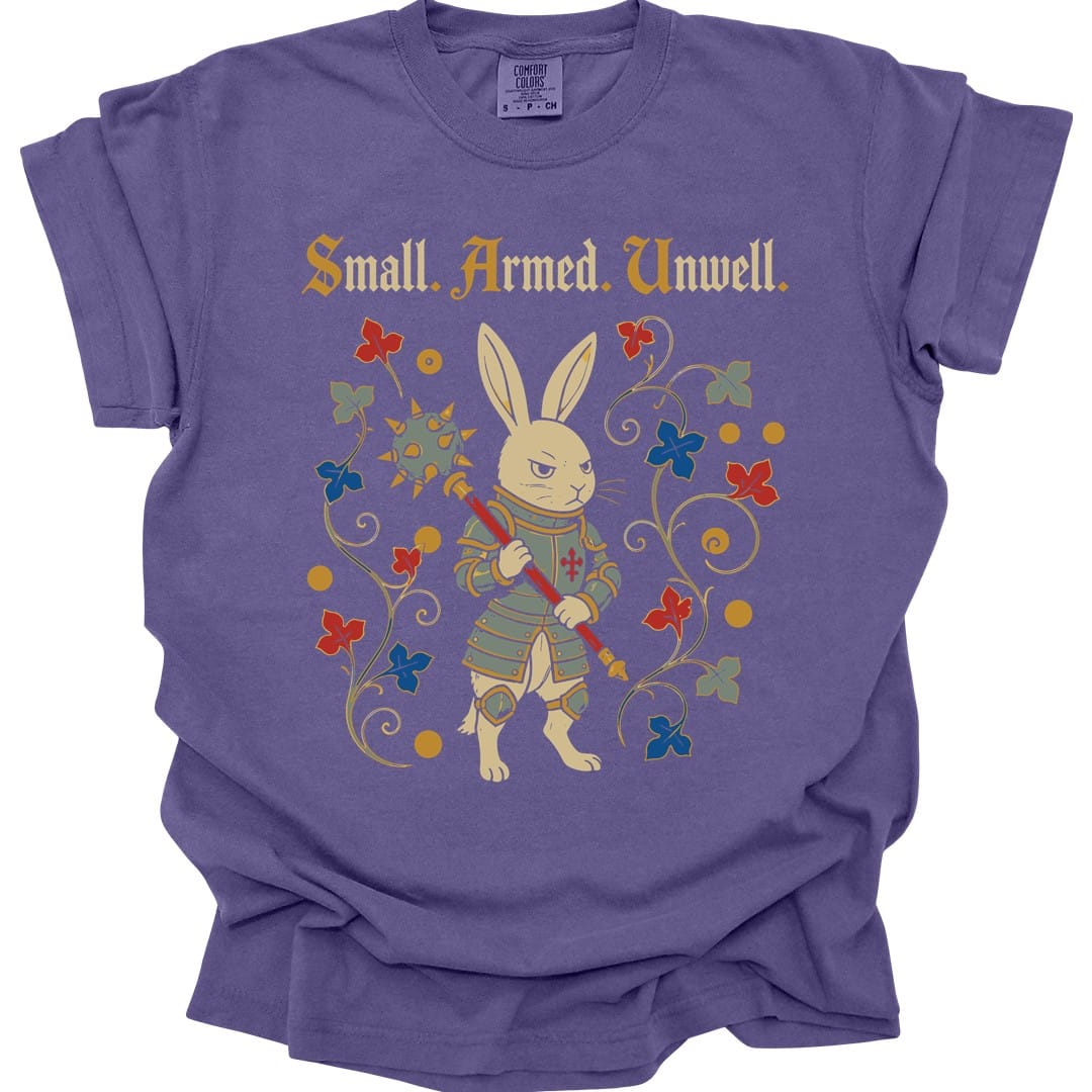 The same Small Armed Unwell rabbit design, on a grape t-shirt.