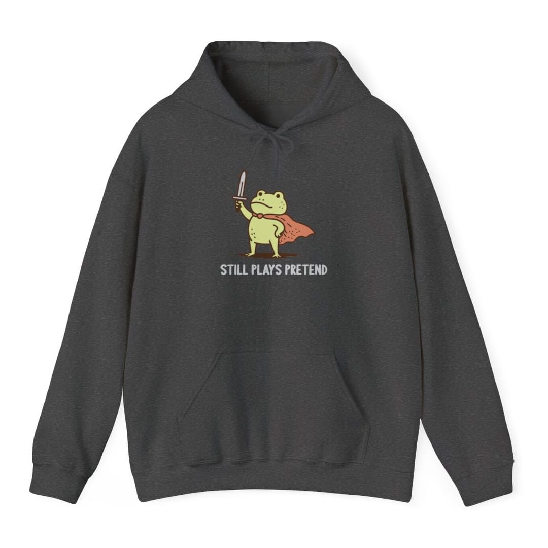 The same Still Plays Pretend frog, small design, on a dark heather hoodie.