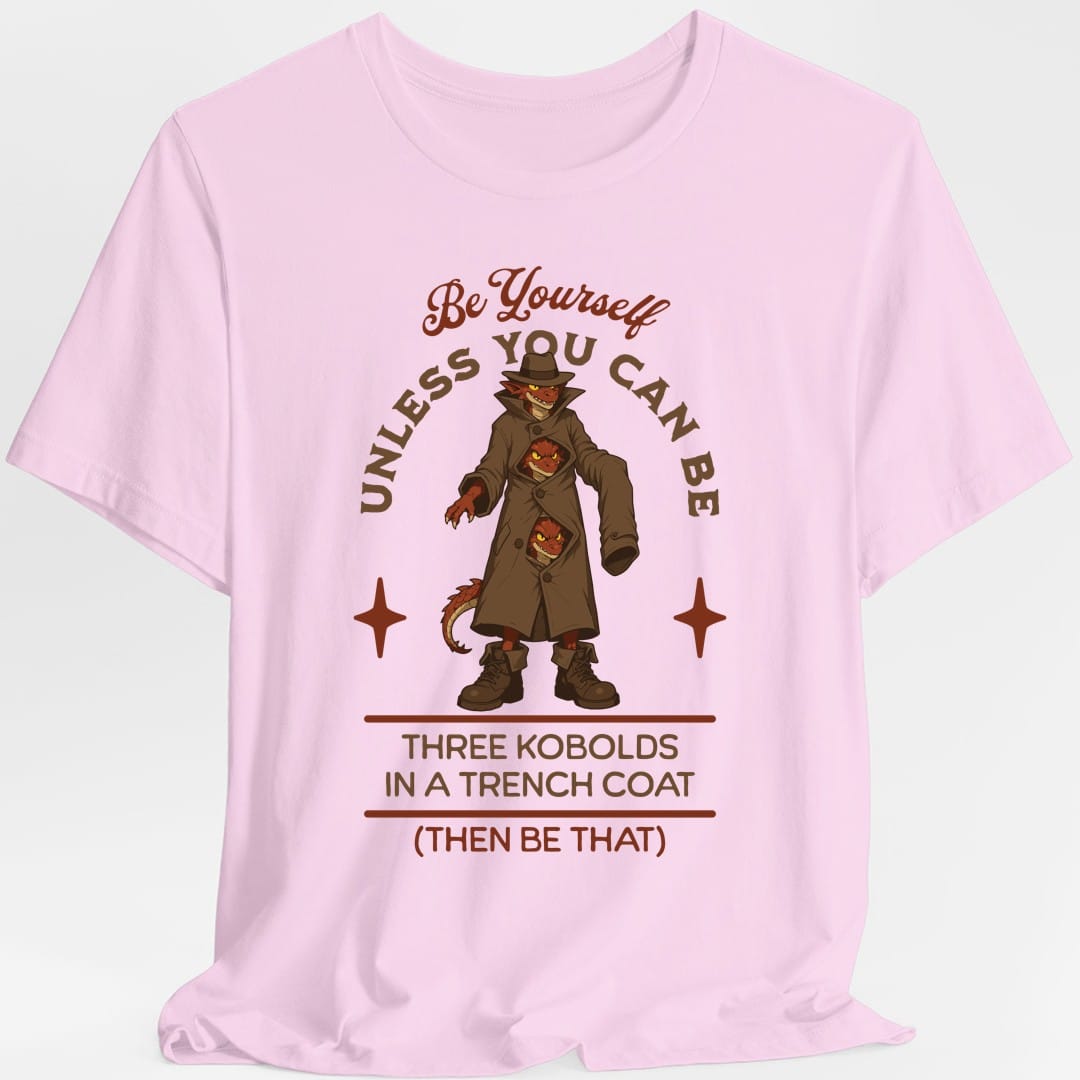 The same Three Kobolds in a Trench Coat design, on a light pink t-shirt.
