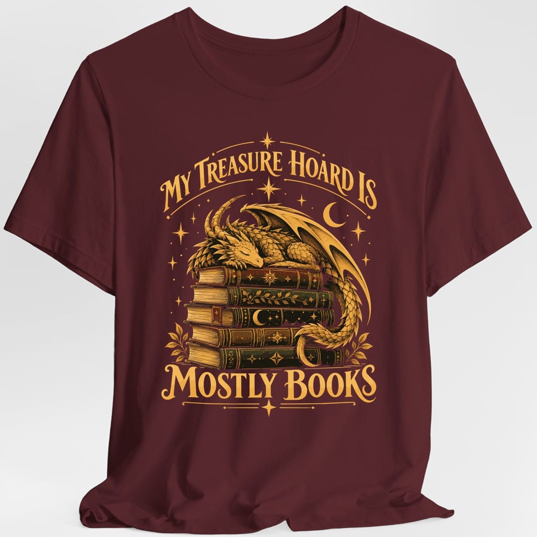 The same Treasure Hoard Mostly Books dragon design, on a maroon t-shirt.