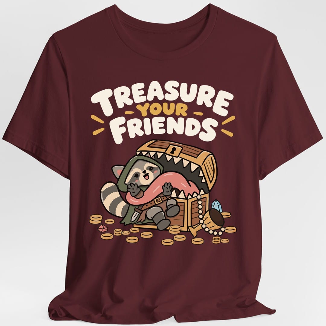 The same Treasure Your Friends raccoon and mimic design, on a maroon t-shirt.