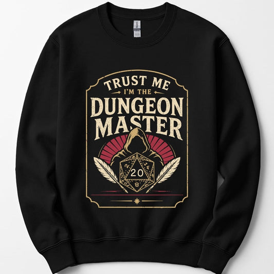 Black sweatshirt. A tall cream badge with a ruled border. "Trust me" sits at the top, then "Dungeon Master" in large capitals. Below, a hooded figure looms behind a twenty-sided die showing 20, flanked by two quill feathers, with a dark red fan behind the hood. Vintage badge style in cream and deep red.