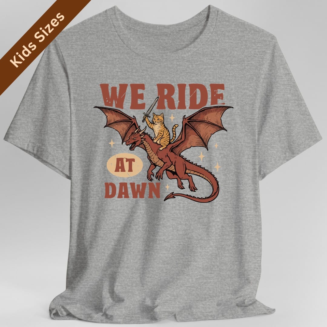 The same We Ride At Dawn dragon cat design, on a sport grey kids t-shirt.