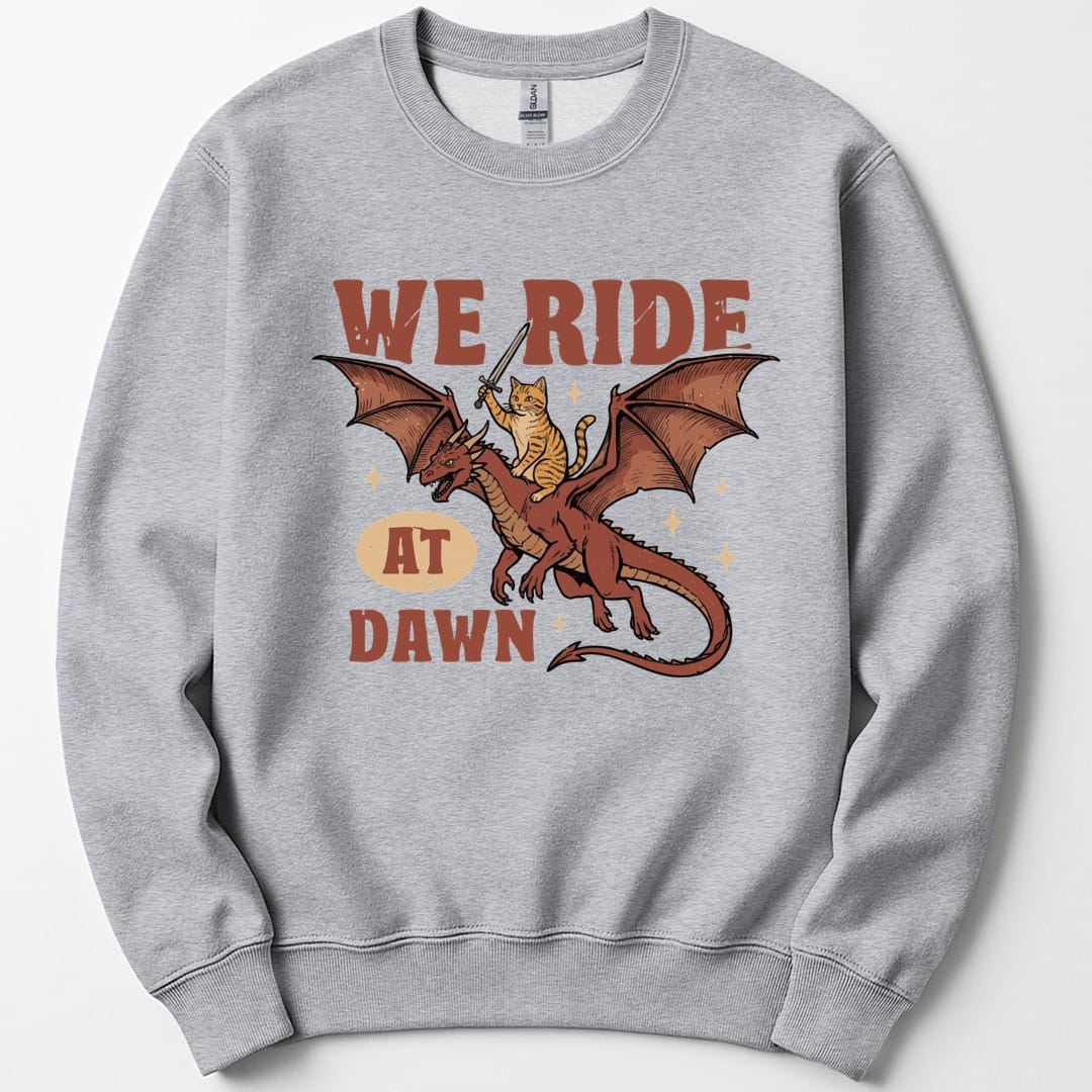 The same We Ride At Dawn dragon cat design, on a sport grey sweatshirt.