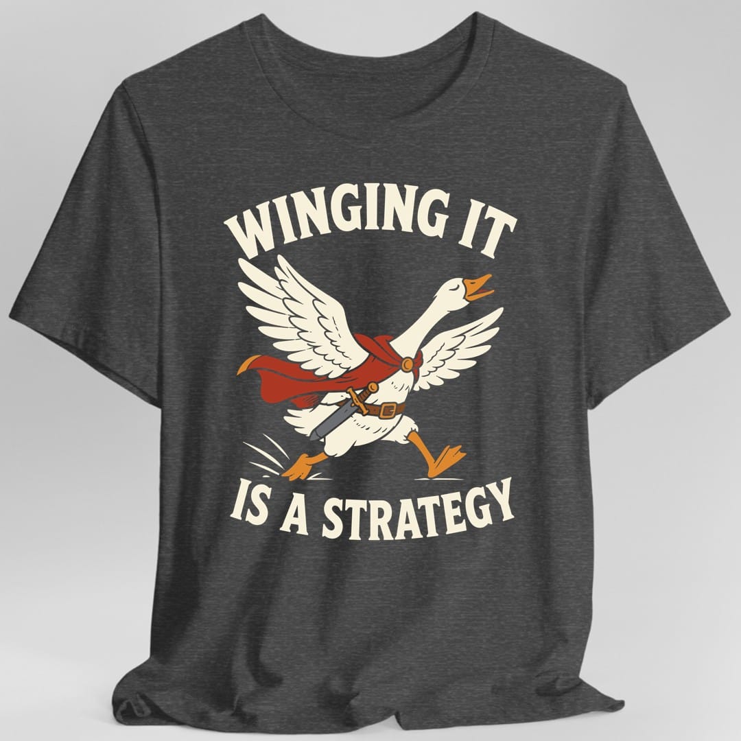 The same Winging It Is a Strategy design, on a dark heather t-shirt.