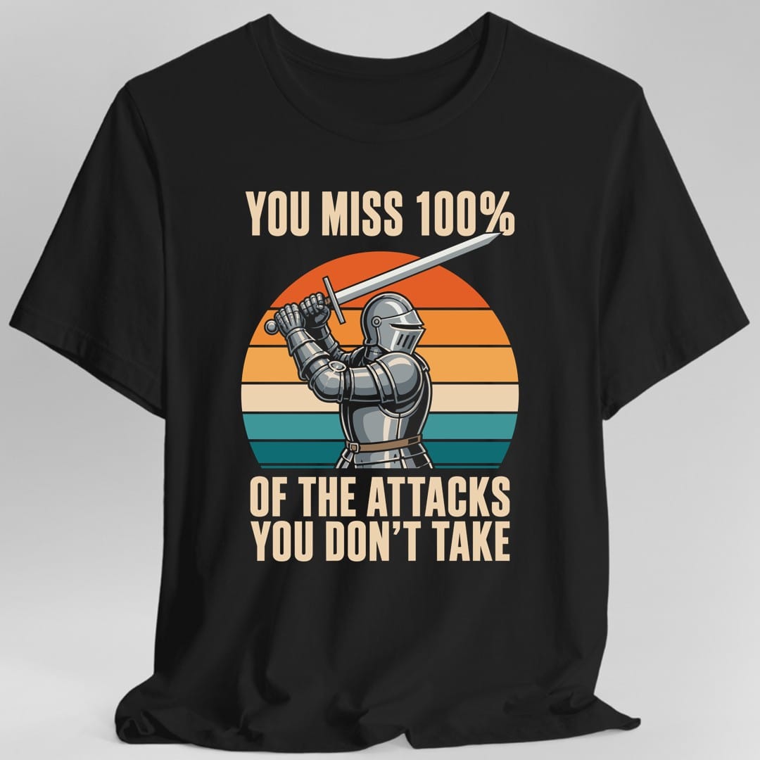 Black t-shirt. The design reads "YOU MISS 100%" across the top and "OF THE ATTACKS YOU DON'T TAKE" in two lines at the bottom, in cream letters. In the middle, a knight in full plate armor and a slitted helmet raises a long silver sword high in one gauntleted fist. Behind him is a striped semicircle sunset running from red and orange at the top down through cream to teal at the bottom.