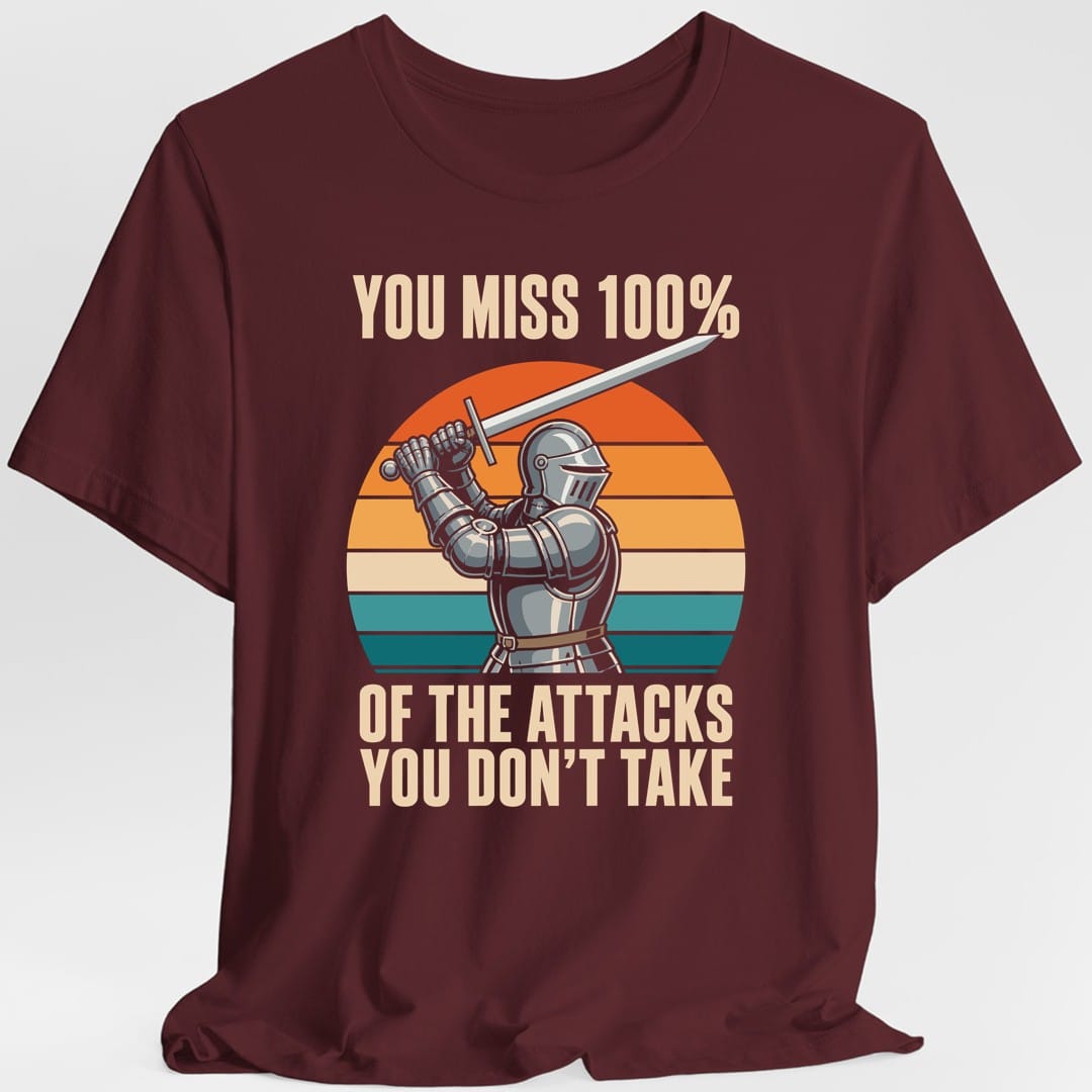 The same You miss 100% knight design, on a maroon t-shirt.