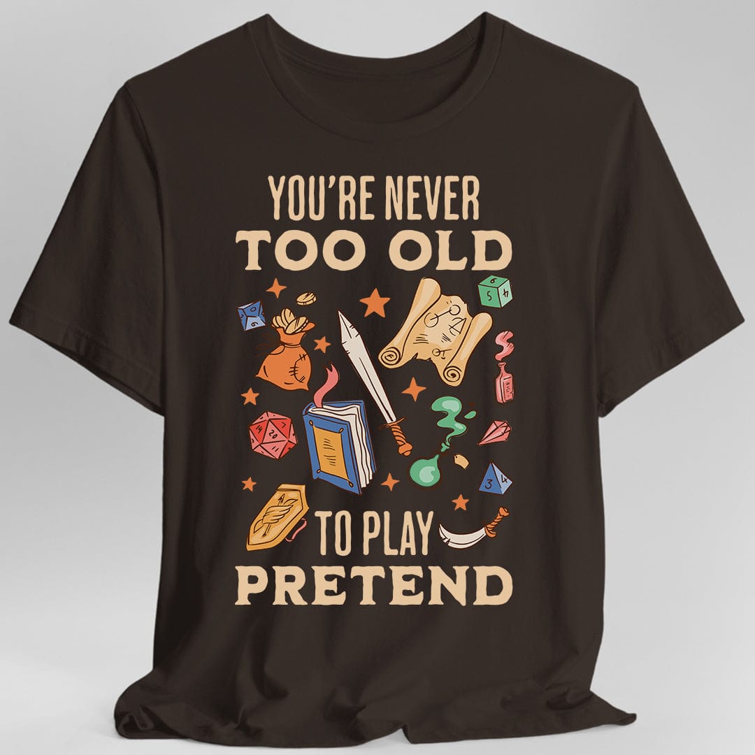 Printify T-Shirt Dark Chocolate / S You’re Never Too Old to Play Pretend – D&D T-Shirt
